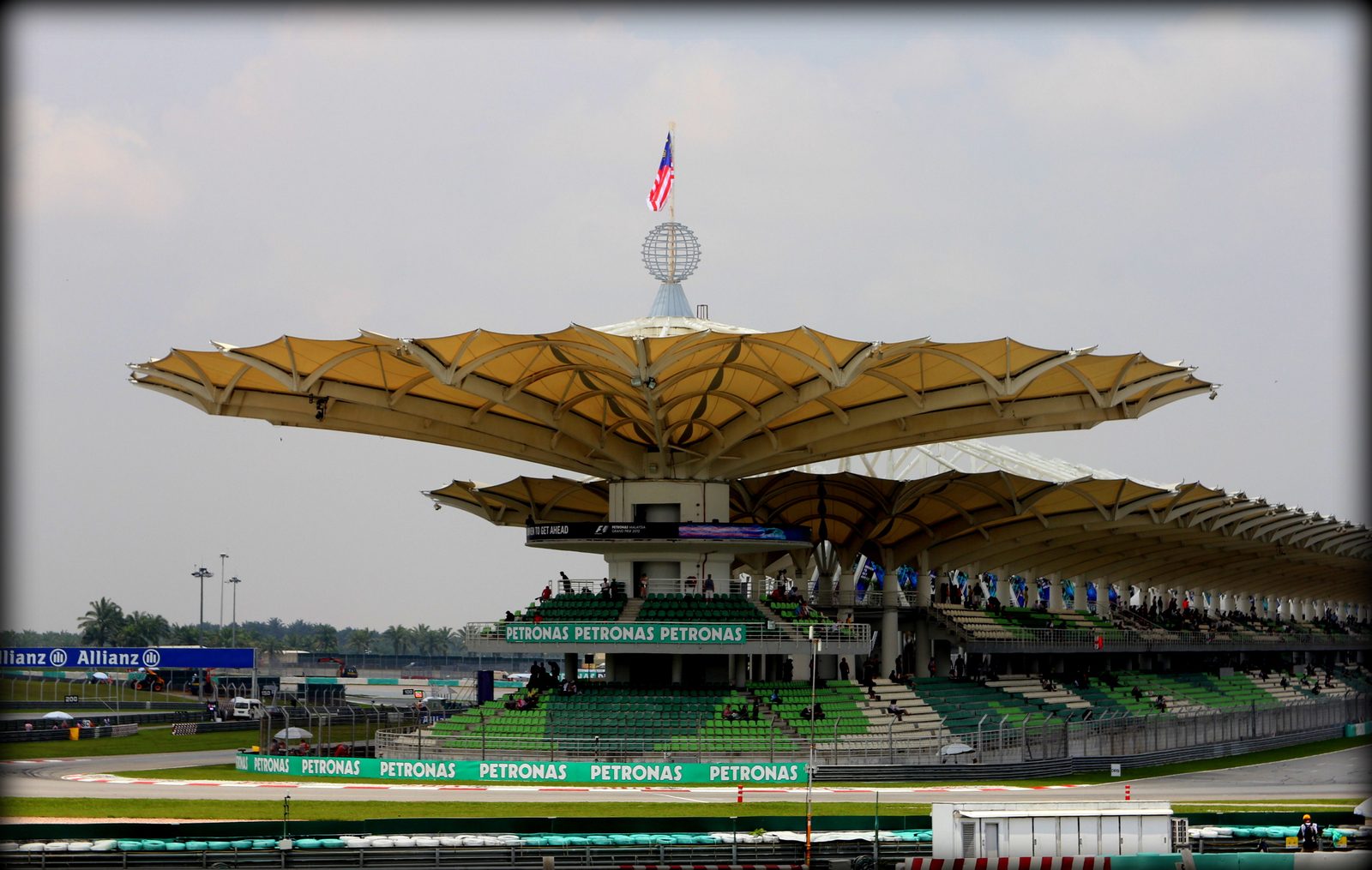 Sepang International Circuit main grandstand with its signature lotus-leaf roof canopy and Malaysian flag